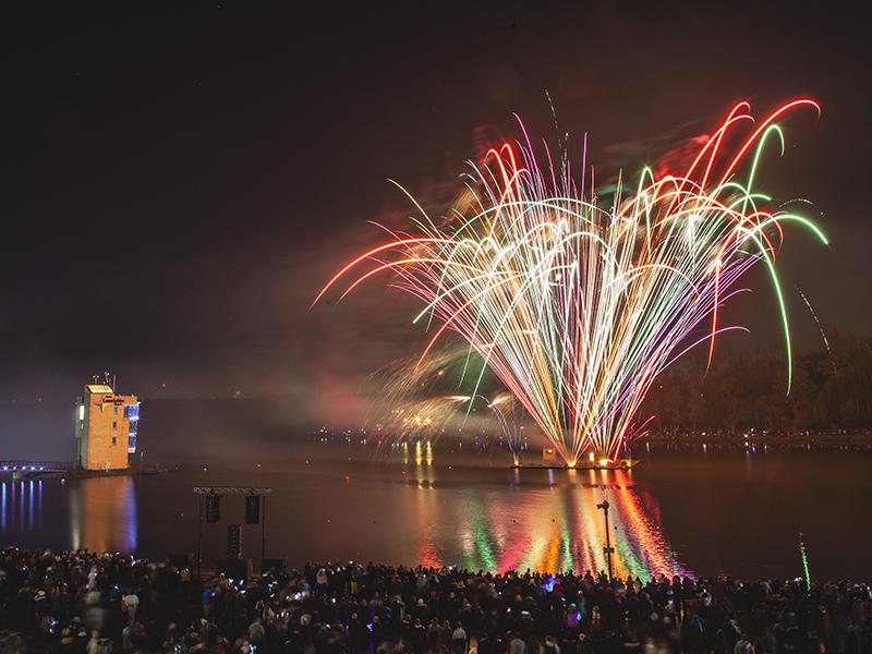 A view across the water of the fireworks display at Strathclyde Country Park, Motherwell.